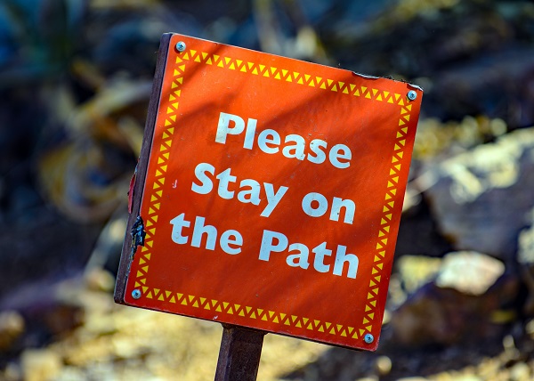 please stay on the path hiking sign