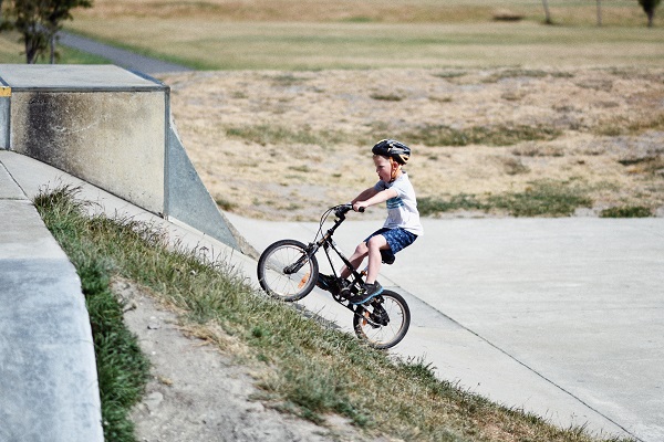 kid on bike wearing helmet